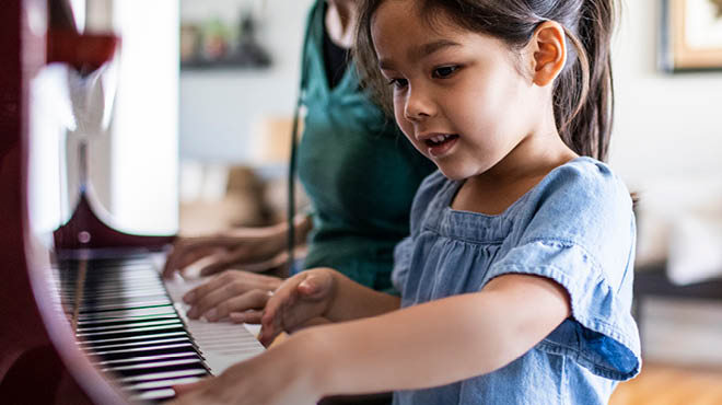 Child at piano keyboard