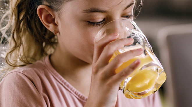 Child drinking orange juice