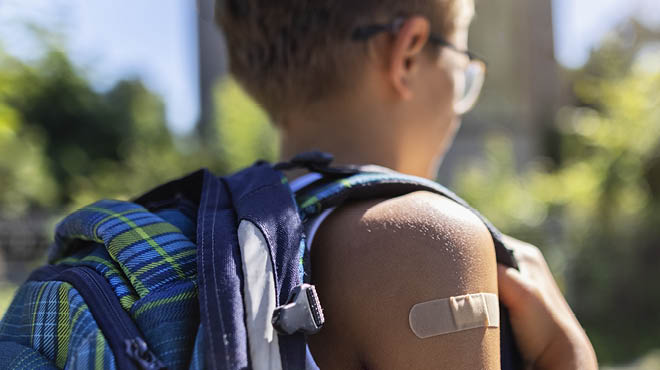 Child with bandage on arm