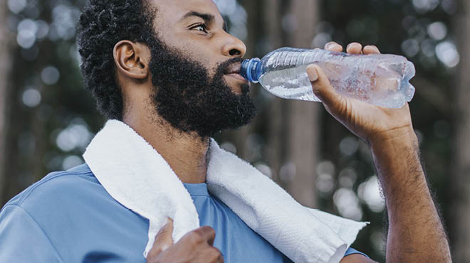 Drinking bottled water towel on neck