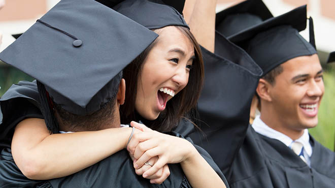 Graduates in black cap and gown