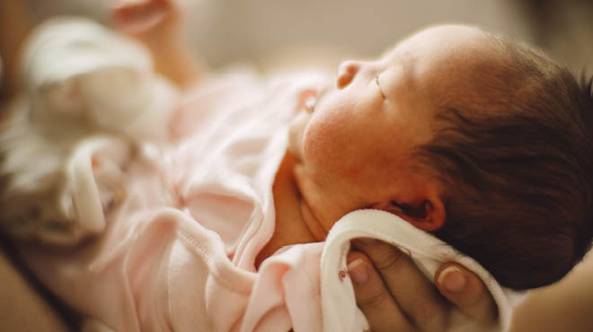 Newborn infant in pink