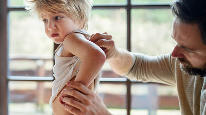 Parent examining child's back