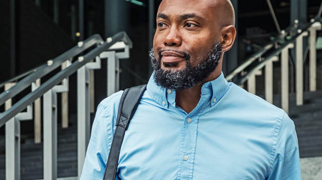 Person with beard wearing a blue shirt