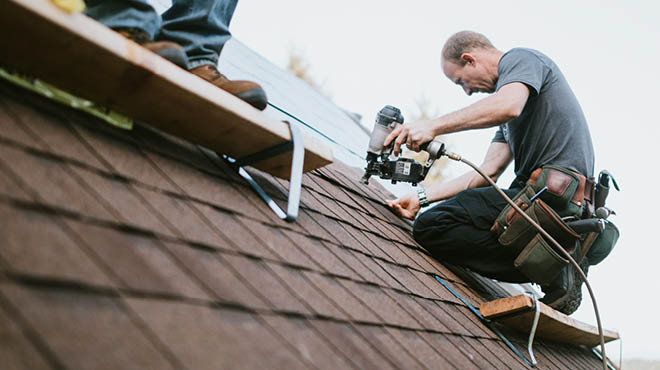 Roofers shingling