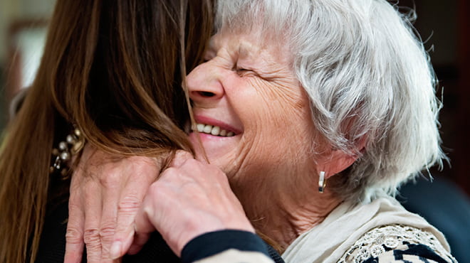 Senior and young person hugging