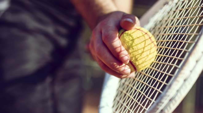 Tennis ball on racket