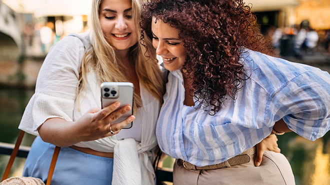 Two people looking at cellphone