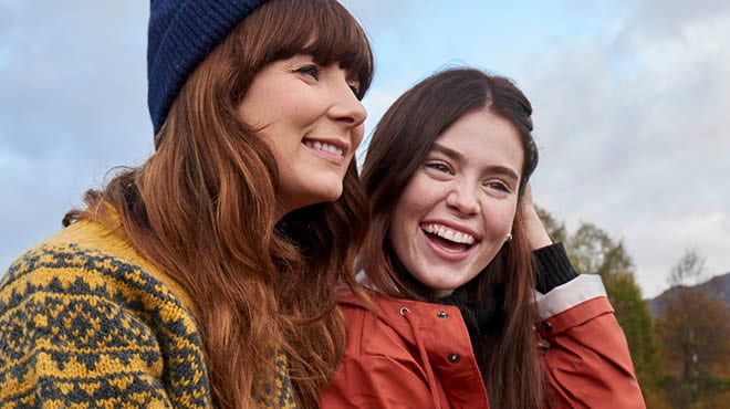 2 smiling ladies in fall outdoor setting