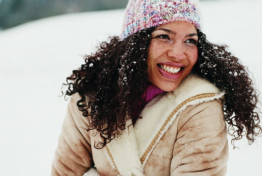 Woman smiling outside in the snow