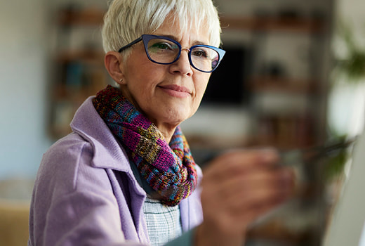 Person with dark hair wearing green sweater