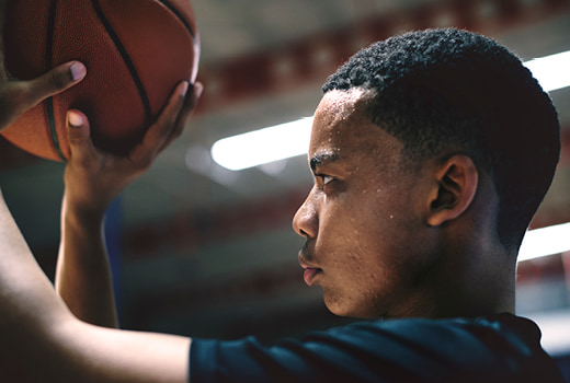 Person with basketball in hand ready to make shot.